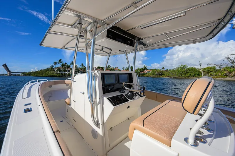  Yacht Photos Pics 2005 Venture 34 Center Console boat on water, featuring sleek design and modern controls.