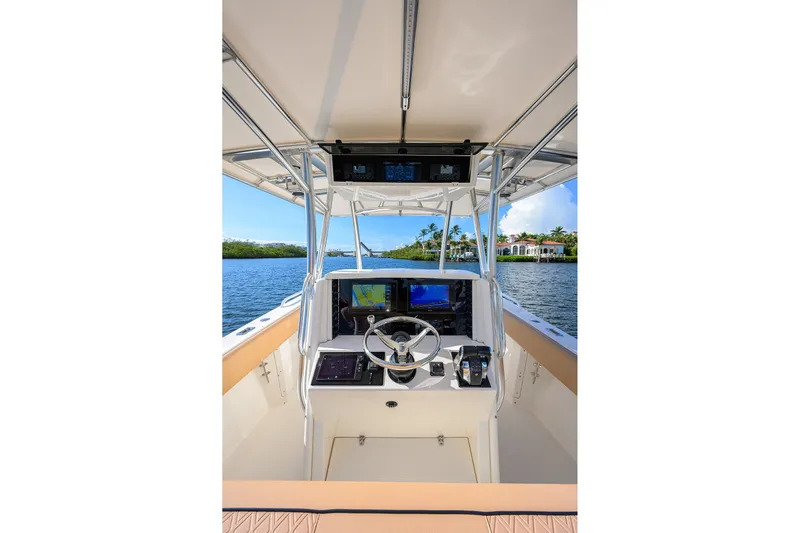  Yacht Photos Pics 2005 Venture 34 Center Console boat interior with navigation equipment on a sunny day.