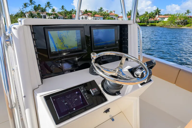  Yacht Photos Pics 2005 Venture 34 Center Console boat dashboard with navigation screens and steering wheel.