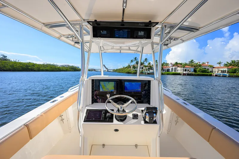  Yacht Photos Pics 2005 Venture 34 Center Console boat interior with navigation screens on a scenic waterway.