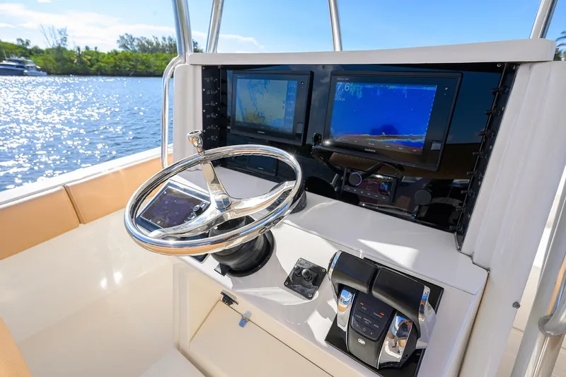  Yacht Photos Pics 2005 Venture 34 Center Console boat dashboard with steering wheel and navigation screens.