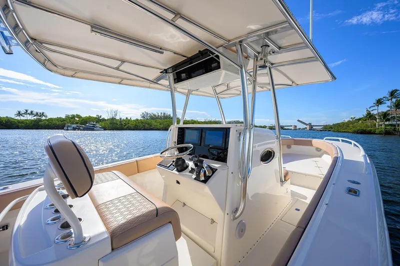  Yacht Photos Pics 2005 Venture 34 Center Console boat on a sunny day, featuring sleek design and modern controls.