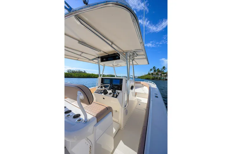  Yacht Photos Pics 2005 Venture 34 Center Console boat interior with helm, under clear blue sky.
