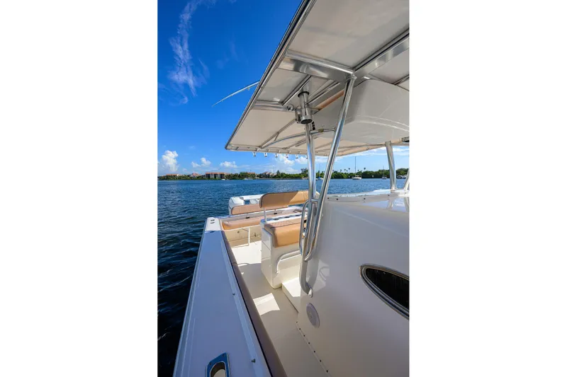  Yacht Photos Pics 2005 Venture 34 Center Console boat on calm water under clear blue sky.