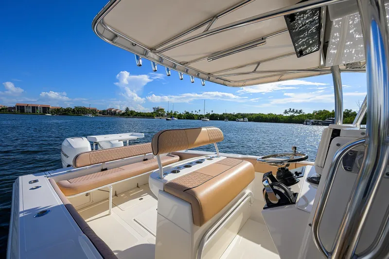  Yacht Photos Pics 2005 Venture 34 Center Console boat interior with seating and steering, overlooking calm waters.