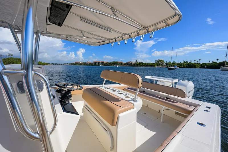  Yacht Photos Pics 2005 Venture 34 Center Console boat on calm water, featuring spacious seating and clear skies.
