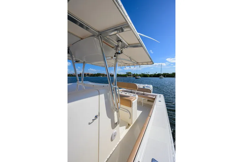  Yacht Photos Pics 2005 Venture 34 Center Console boat on calm water under clear blue sky.