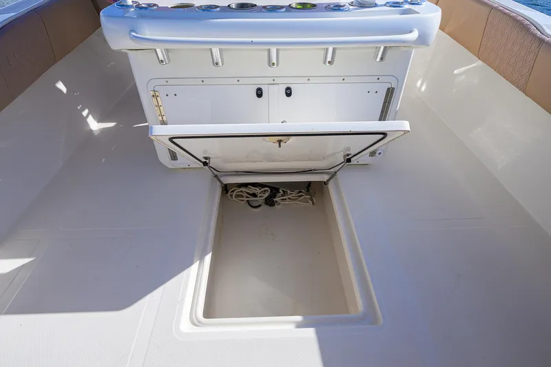  Yacht Photos Pics 2005 Venture 34 Center Console boat with open storage compartment and control panel.