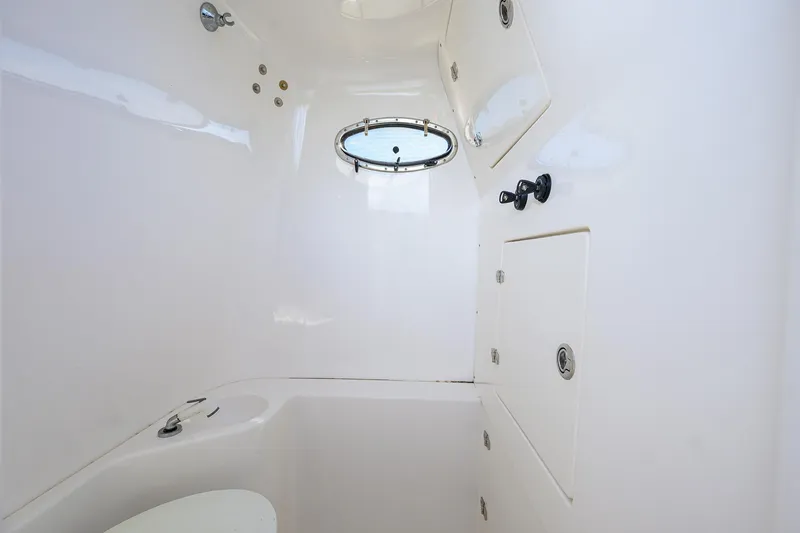  Yacht Photos Pics 2005 Venture 34 Center Console interior cabin with porthole and storage compartments.