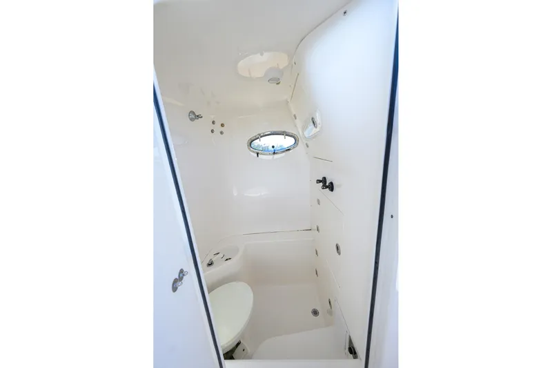  Yacht Photos Pics 2005 Venture 34 Center Console boat interior cabin with porthole and toilet.