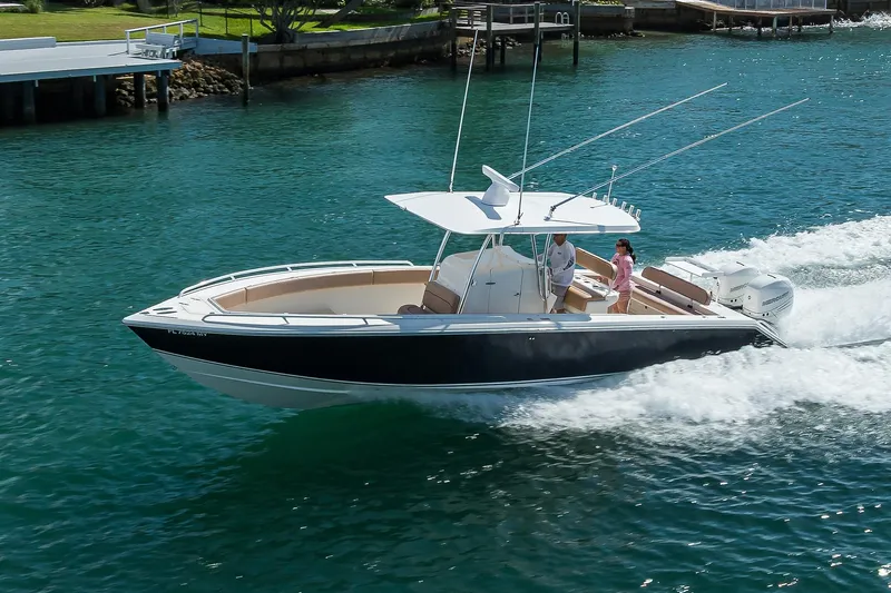  Yacht Photos Pics 2005 Venture 34 Center Console boat cruising on clear blue water.