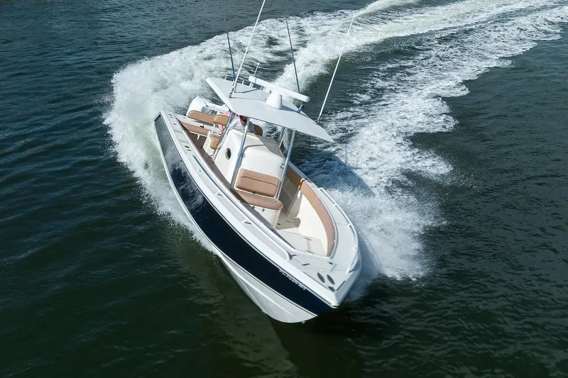  Yacht Photos Pics 2005 Venture 34 Center Console boat cruising on open water.