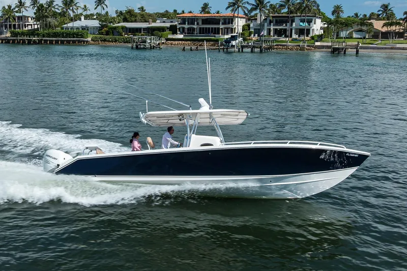 Yacht Photos Pics 2005 Venture 34 Center Console boat cruising on a scenic waterway.