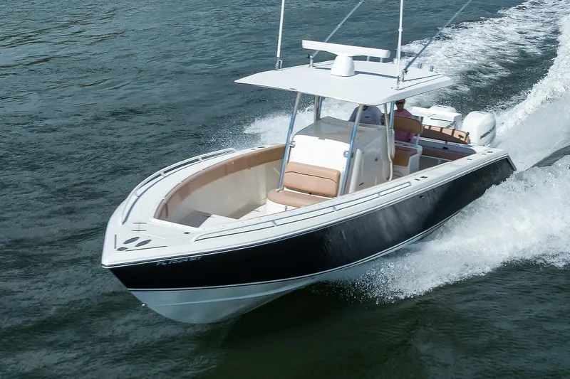  Yacht Photos Pics 2005 Venture 34 Center Console boat cruising on water, showcasing sleek design and performance.