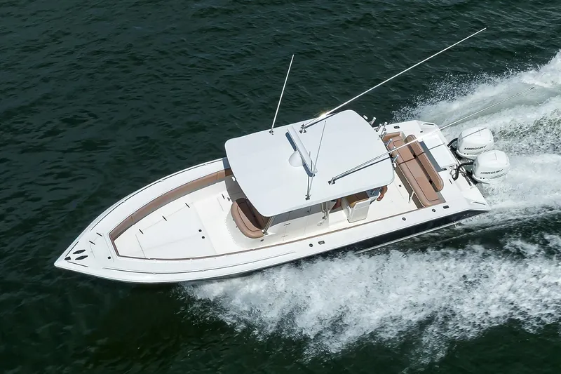  Yacht Photos Pics 2005 Venture 34 Center Console boat cruising on open water, aerial view.