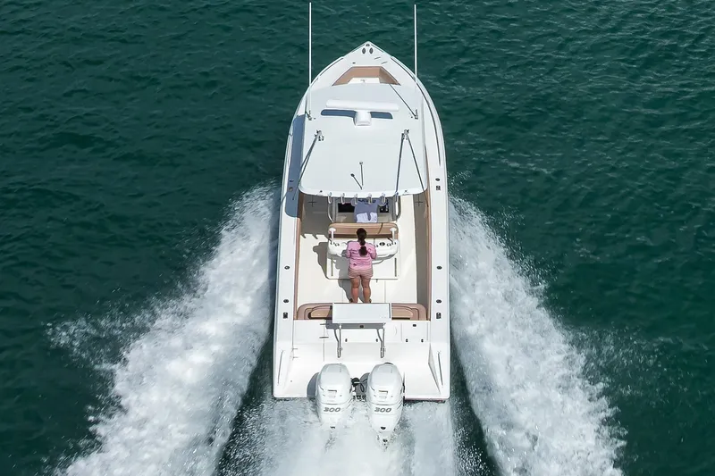  Yacht Photos Pics 2005 Venture 34 Center Console boat cruising on open water, aerial view.