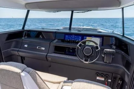  Yacht Photos Pics 2025 Axopar 45 XC Cross Cabin interior with modern dashboard and ocean view.