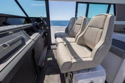 Yacht Photos Pics 2025 Axopar 45 XC Cross Cabin interior with modern seating and ocean view.