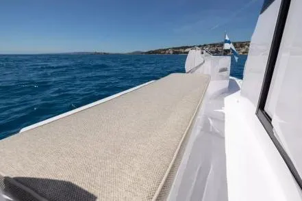  Yacht Photos Pics 2025 Axopar 45 XC Cross Cabin boat on open sea, featuring sleek deck design.