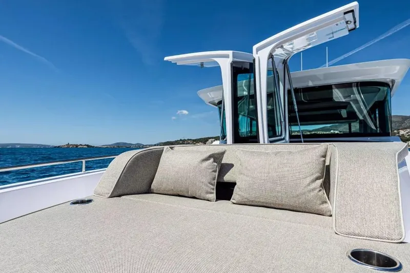  Yacht Photos Pics 2025 Axopar 45 XC Cross Cabin luxury deck with cushions, ocean view.