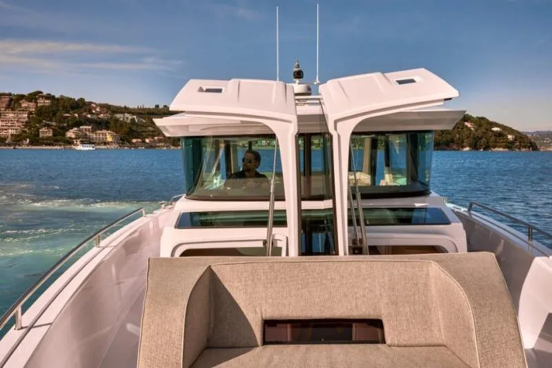  Yacht Photos Pics 2025 Axopar 45 XC Cross Cabin cruising on a scenic lake with modern design.