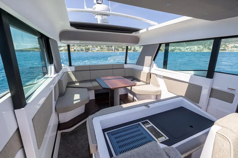  Yacht Photos Pics 2025 Axopar 45 XC Cross Cabin interior with panoramic windows and seating area.