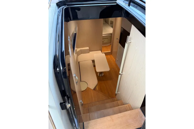 Kawa Yacht Photos Pics Interior view of 2023 SACS Rebel 55 yacht, featuring modern seating and wooden flooring.