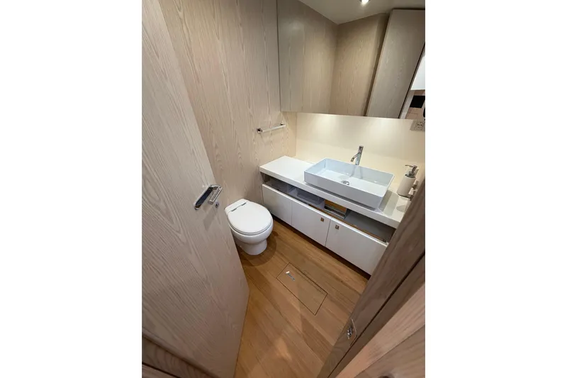 Kawa Yacht Photos Pics Modern bathroom interior on 2023 SACS Rebel 55 yacht, featuring sleek sink and toilet.