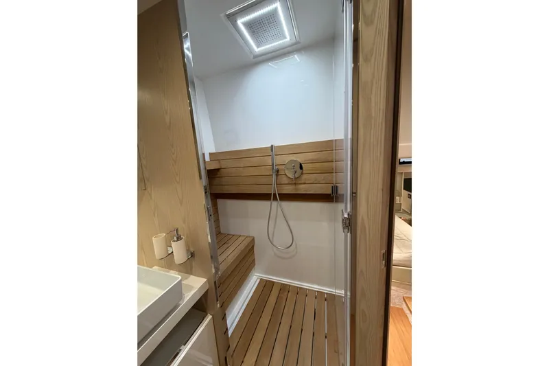 Kawa Yacht Photos Pics Modern shower area in 2023 SACS Rebel 55 yacht with wooden accents.