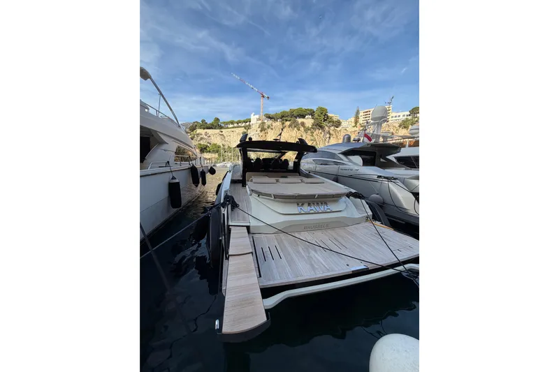 Kawa Yacht Photos Pics 2023 SACS Rebel 55 yacht docked in a marina, showcasing sleek design and luxury features.