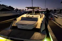 2022 Solaris Power 44 Open yacht docked at sunset, illuminated with soft lighting.