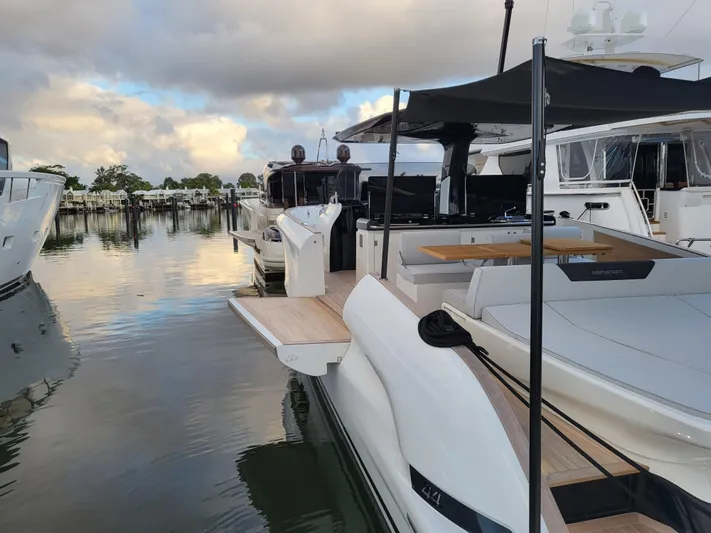  Yacht Photos Pics 2022 Solaris Power 44 Open yacht docked at marina, showcasing sleek design and spacious deck.