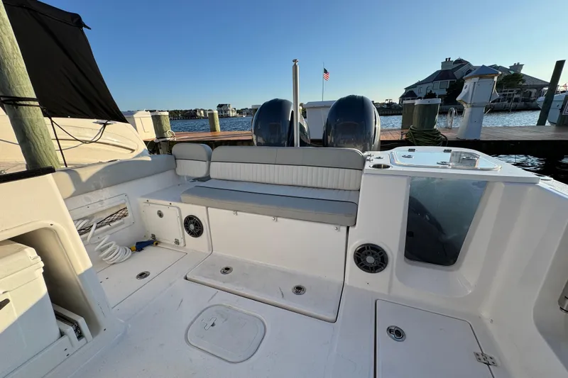  Yacht Photos Pics 2023 Sea Fox 268 Traveler boat interior with seating and dual engines at dock.
