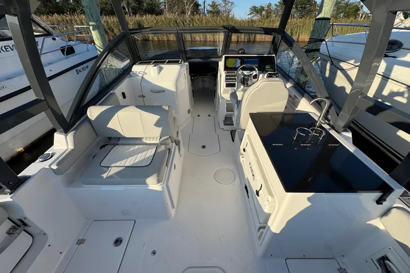  Yacht Photos Pics 2023 Sea Fox 268 Traveler boat interior with seating and helm station.