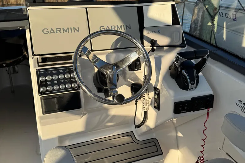  Yacht Photos Pics 2023 Sea Fox 268 Traveler boat dashboard with Garmin displays and steering wheel.