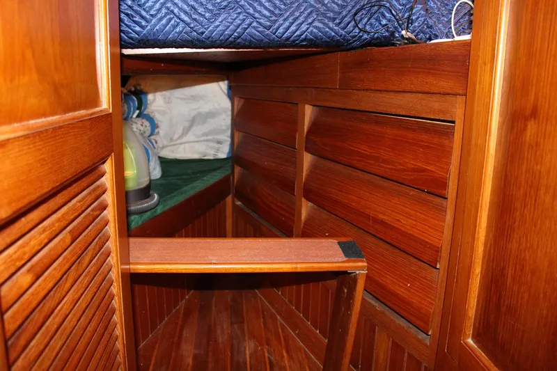Divine Miss Em Yacht Photos Pics Interior of 1990 Slocum 43 sailboat with wooden paneling and storage space.