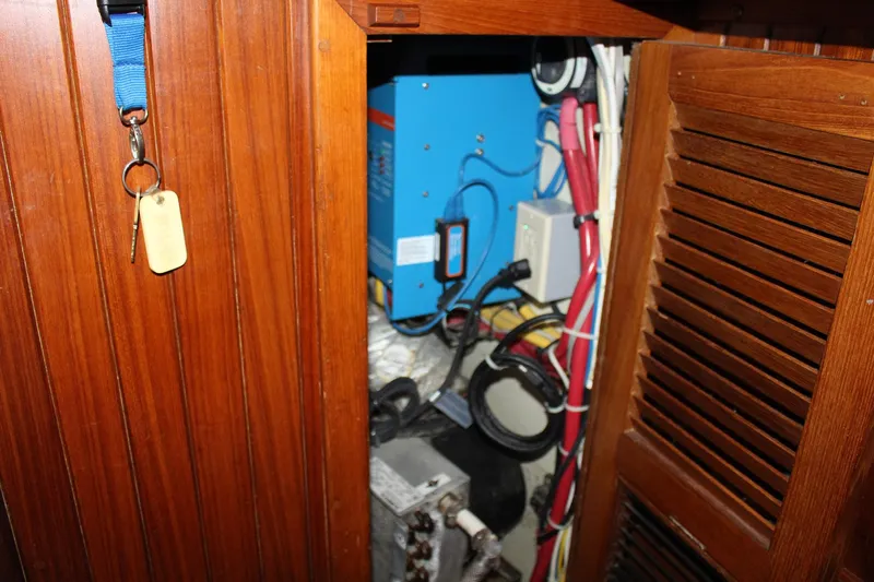 Divine Miss Em Yacht Photos Pics Electrical panel inside a 1990 Slocum 43 sailboat with wooden cabinetry.