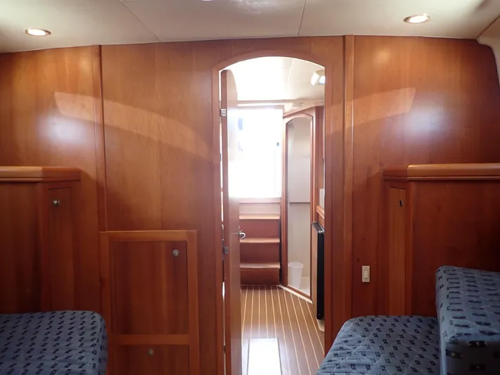  Yacht Photos Pics Interior of 2004 Mainship 34 Rum Runner II with wood paneling and cozy seating.