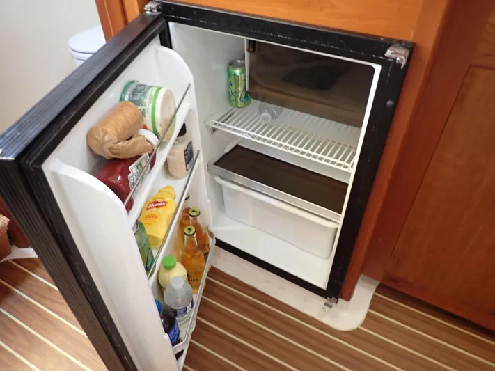  Yacht Photos Pics Open refrigerator in 2004 Mainship 34 Rum Runner II, stocked with various food and drinks.