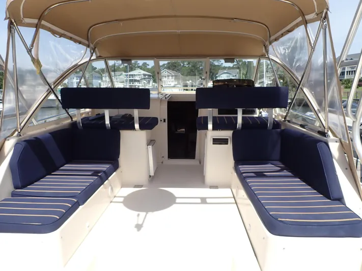  Yacht Photos Pics 2004 Mainship 34 Rum Runner II boat interior with blue seating and canopy.