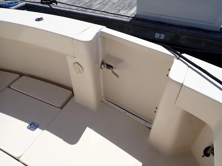  Yacht Photos Pics 2004 Mainship 34 Rum Runner II boat deck with seating and storage compartment.