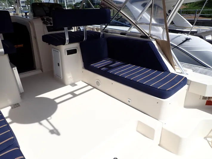  Yacht Photos Pics 2004 Mainship 34 Rum Runner II boat interior with blue cushioned seating.