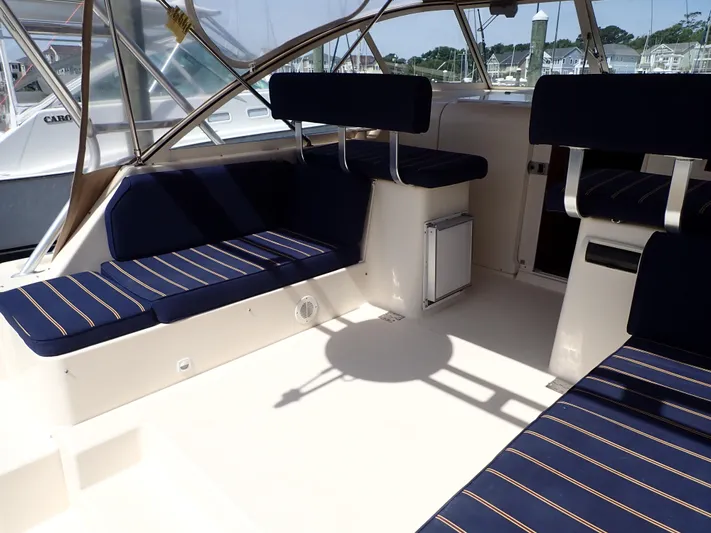  Yacht Photos Pics 2004 Mainship 34 Rum Runner II interior with blue striped seating and spacious layout.