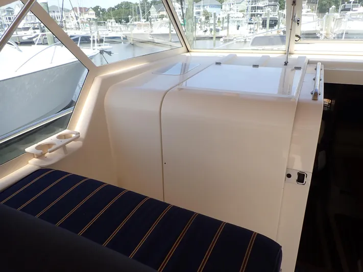  Yacht Photos Pics 2004 Mainship 34 Rum Runner II interior with striped seating and marina view.