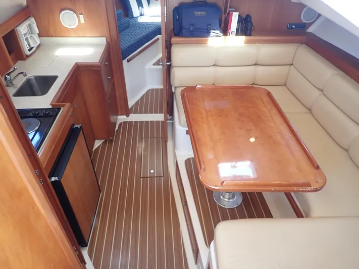  Yacht Photos Pics 2004 Mainship 34 Rum Runner II interior with kitchenette and dining area.
