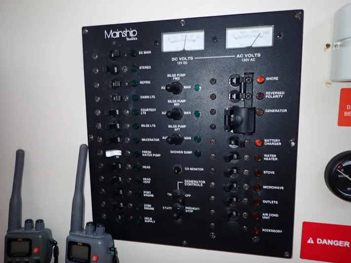  Yacht Photos Pics Control panel of a 2004 Mainship 34 Rum Runner II boat with various switches and gauges.