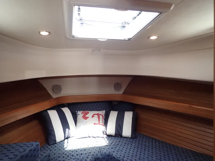  Yacht Photos Pics Cozy cabin interior of 2004 Mainship 34 Rum Runner II with nautical-themed cushions.