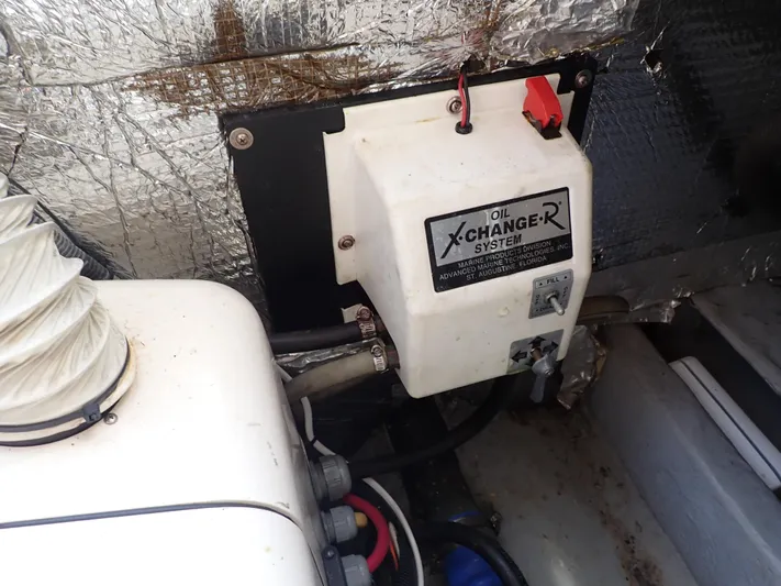  Yacht Photos Pics Engine compartment of 2004 Mainship 34 Rum Runner II with oil changer system.