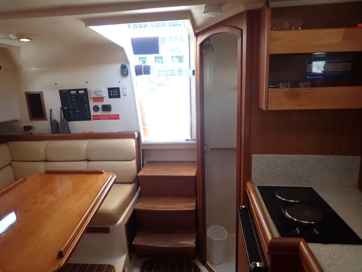  Yacht Photos Pics Interior of 2004 Mainship 34 Rum Runner II with dining area and kitchenette.