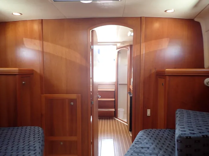  Yacht Photos Pics 2004 Mainship 34 Rum Runner II cabin interior with wood paneling and seating.